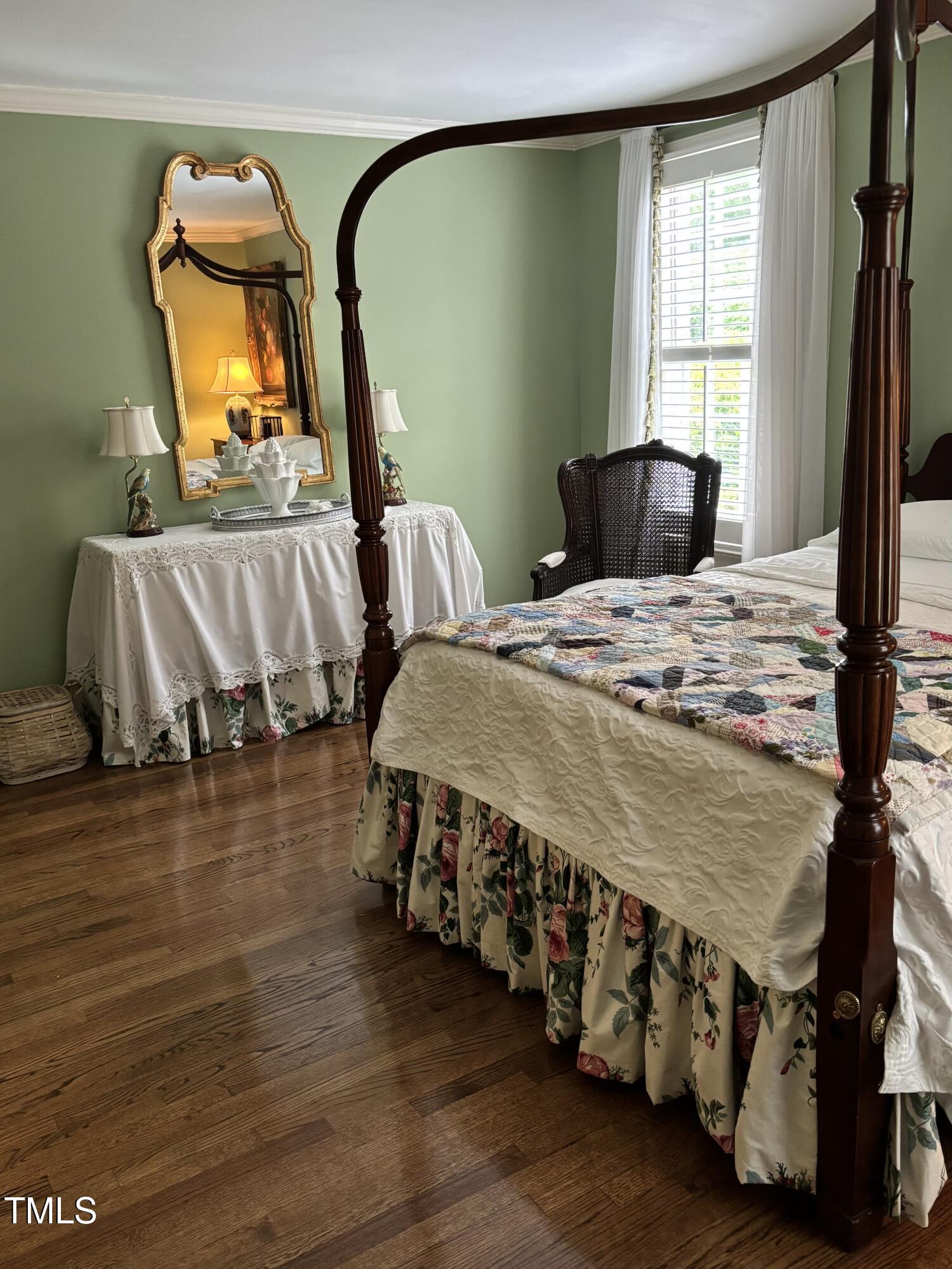 9301 Brookton Court Raleigh, NC 27615 - Photo 19 of 29 a bedroom with a bed a mirror and a flat tv screen on dresser