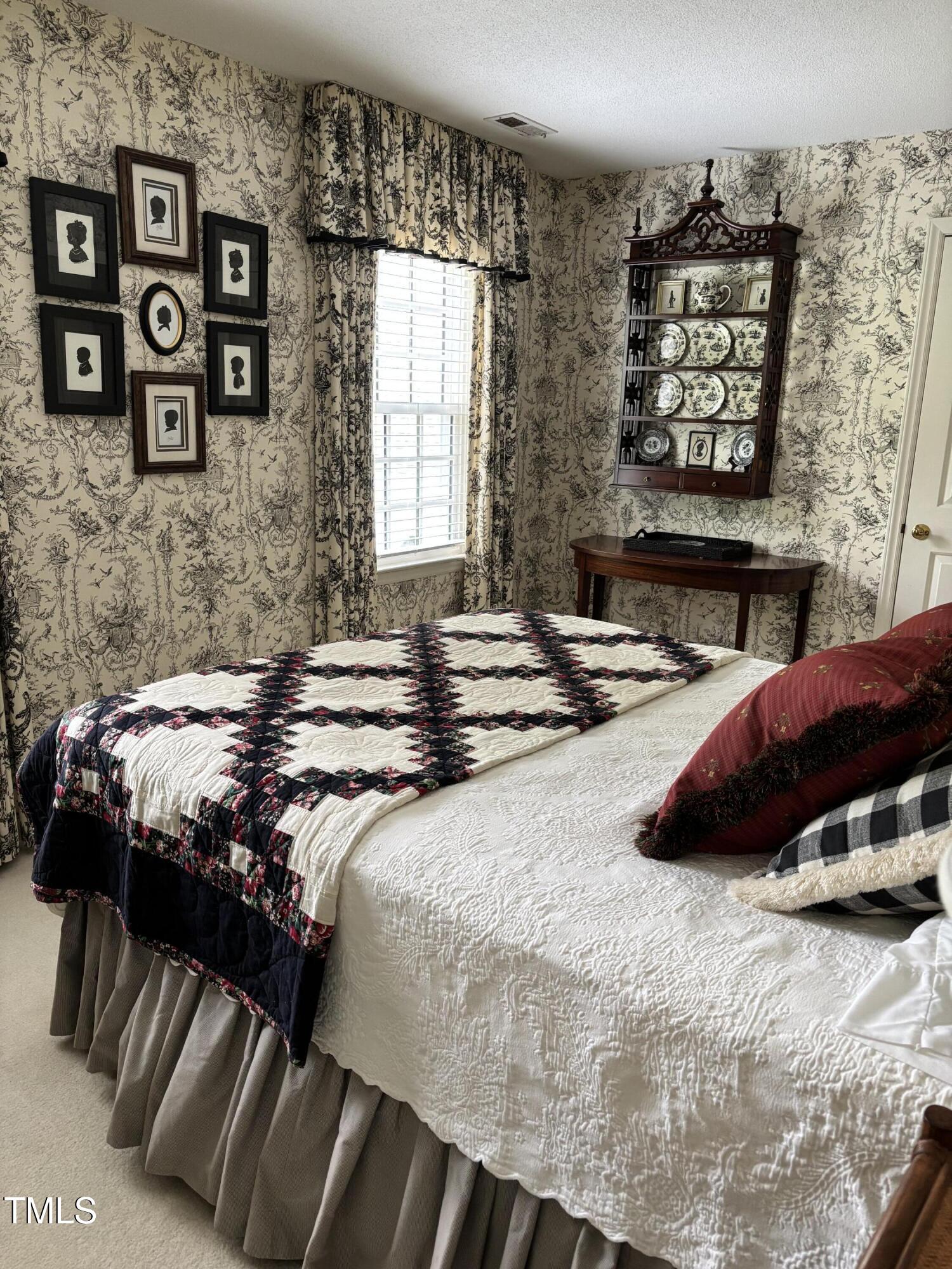 9301 Brookton Court Raleigh, NC 27615 - Photo 26 of 29 a bedroom with a bed and a wall painting
