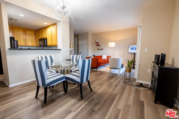 a dining room with furniture and wooden floor