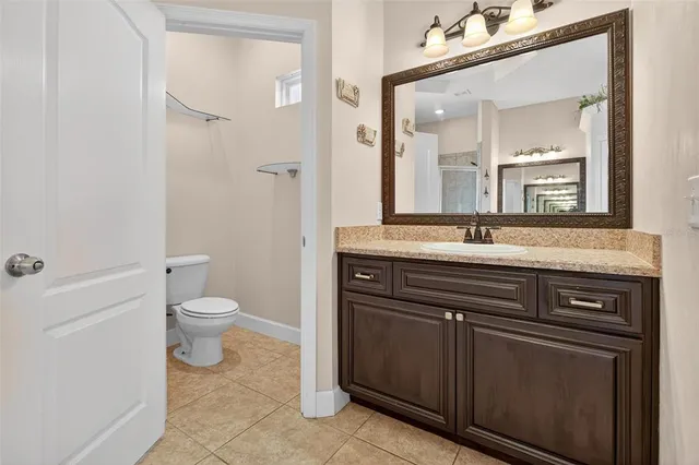 a view of patio with table and chairs under an umbrella