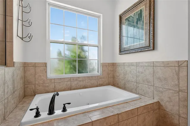 a view of a swimming pool with a patio and a garden