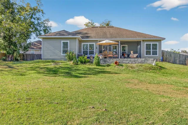 a park view with a fountain plants and large tree