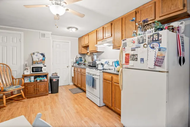 a kitchen with stainless steel appliances a refrigerator and a stove top oven
