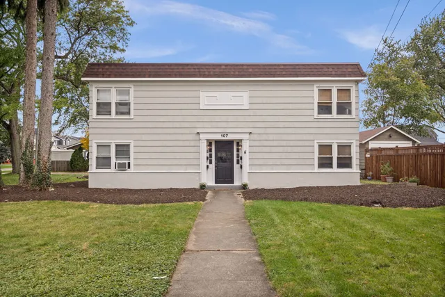 a front view of house with yard and green space