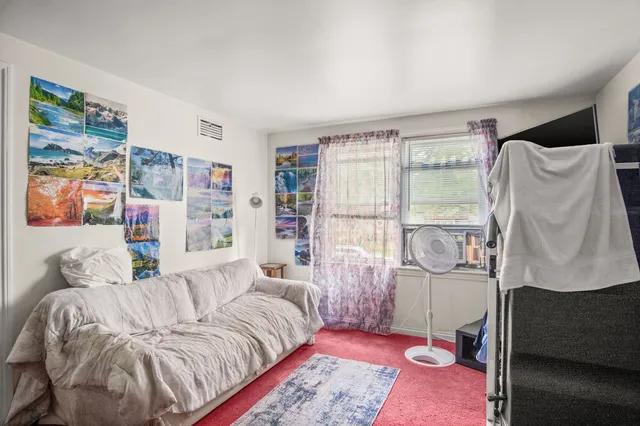 a bedroom with a bed couch and a window