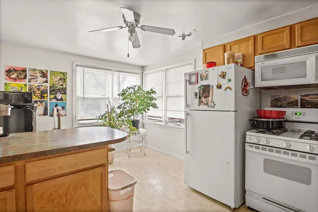 a kitchen with stainless steel appliances a refrigerator sink and cabinets