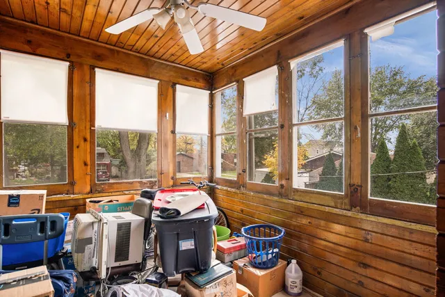 a living room with furniture and floor to ceiling windows
