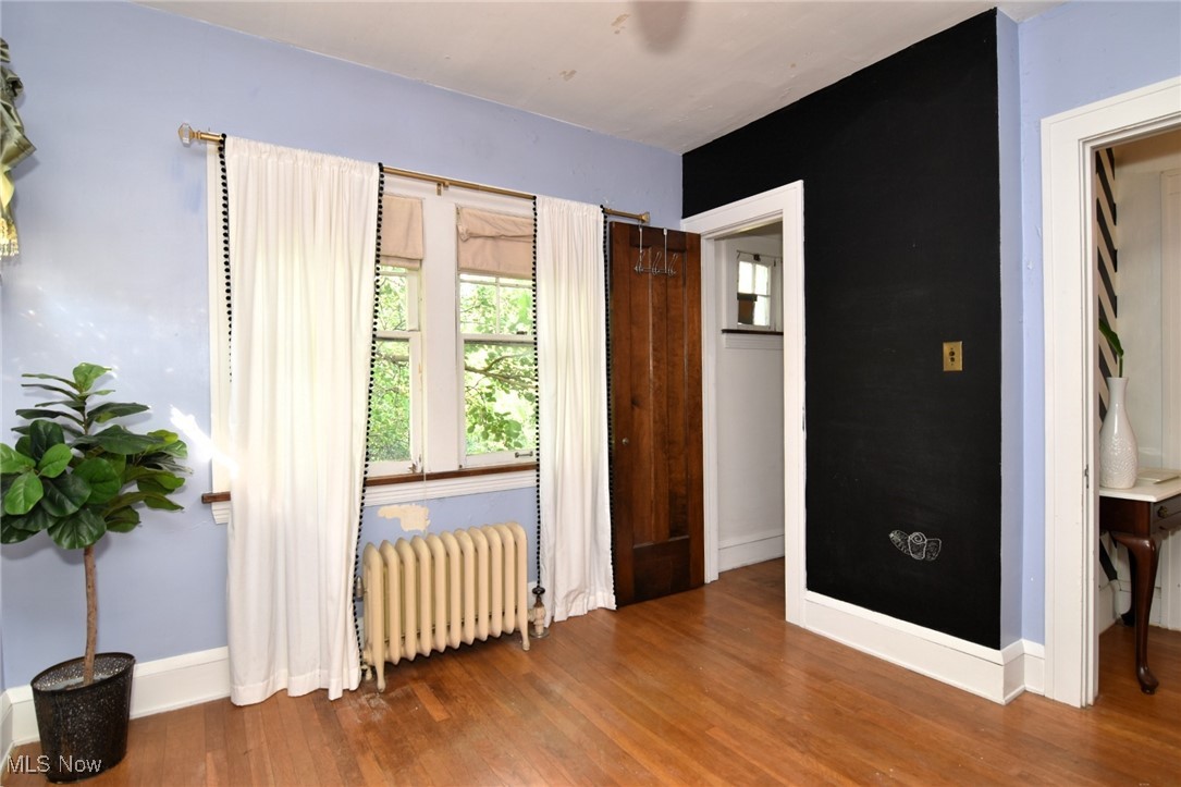 17930 Rosecliff Road Cleveland, OH 44119 - Photo 33 of 50 Bedroom with radiator and wood finished floors