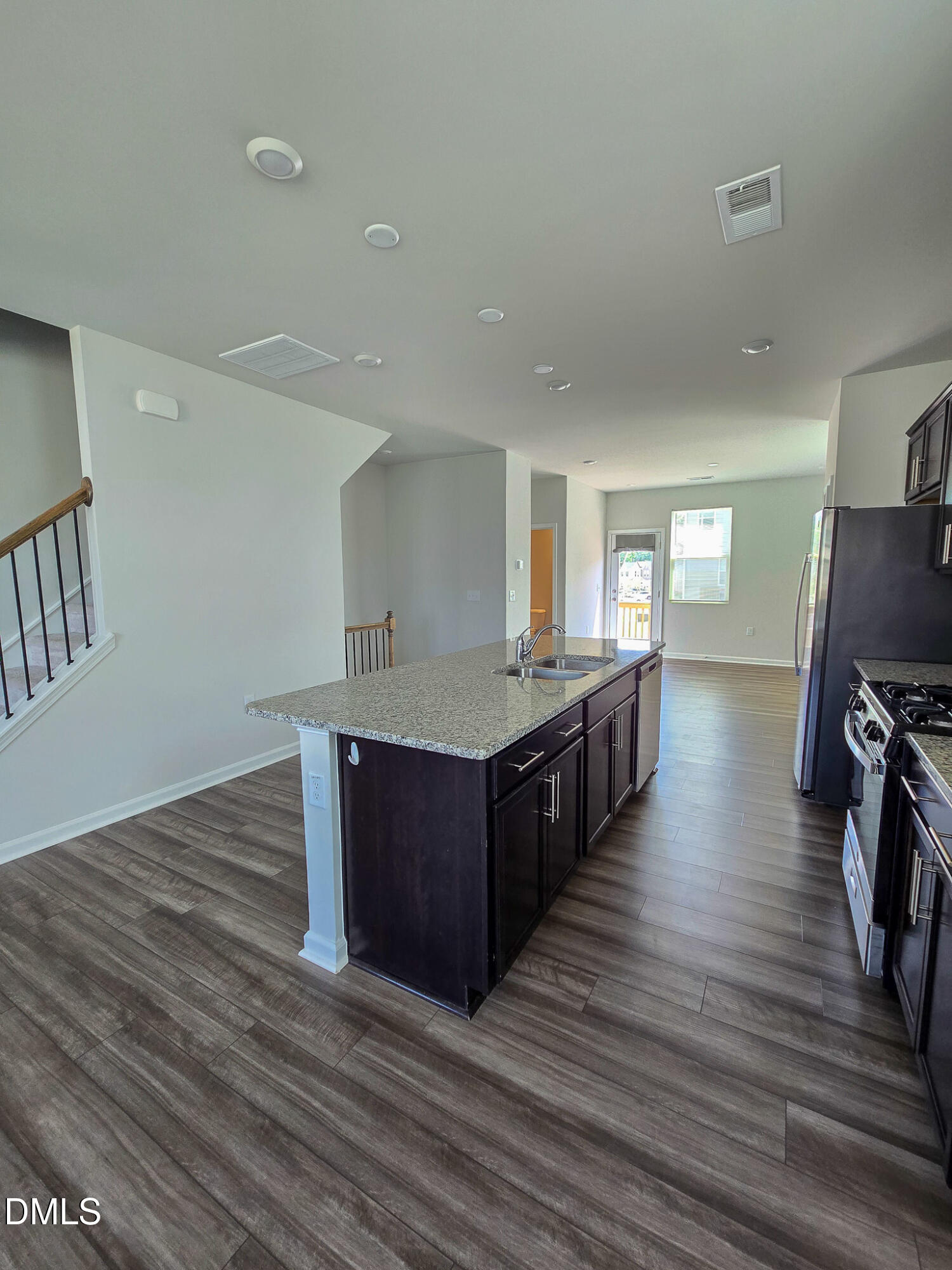 2431 Kasota Lane Raleigh, NC 27610 - Photo 15 of 46 a kitchen with wooden floors and center island