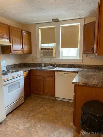 a kitchen with a stove a sink a microwave and cabinets