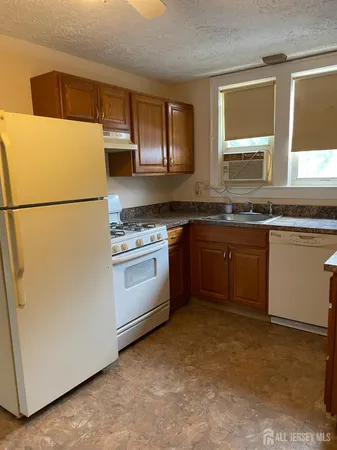 a kitchen with a white cabinets and white appliances