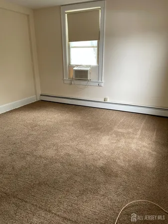 an empty room with closet and mirror