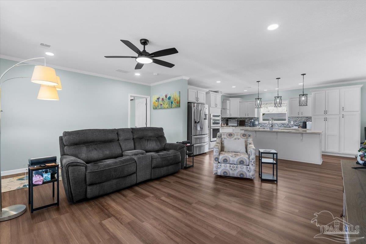 4955 Blue Ribbon Drive Milton, FL 32583 - Photo 8 of 32 a living room with furniture and kitchen view