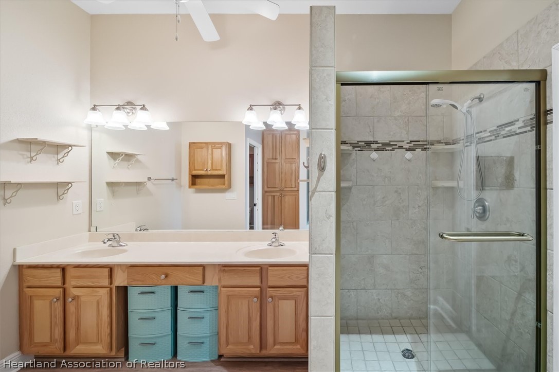 5224 Haw Branch Road Sebring, FL 33875 - Photo 22 of 40 a bathroom with a double vanity sink mirror and shower