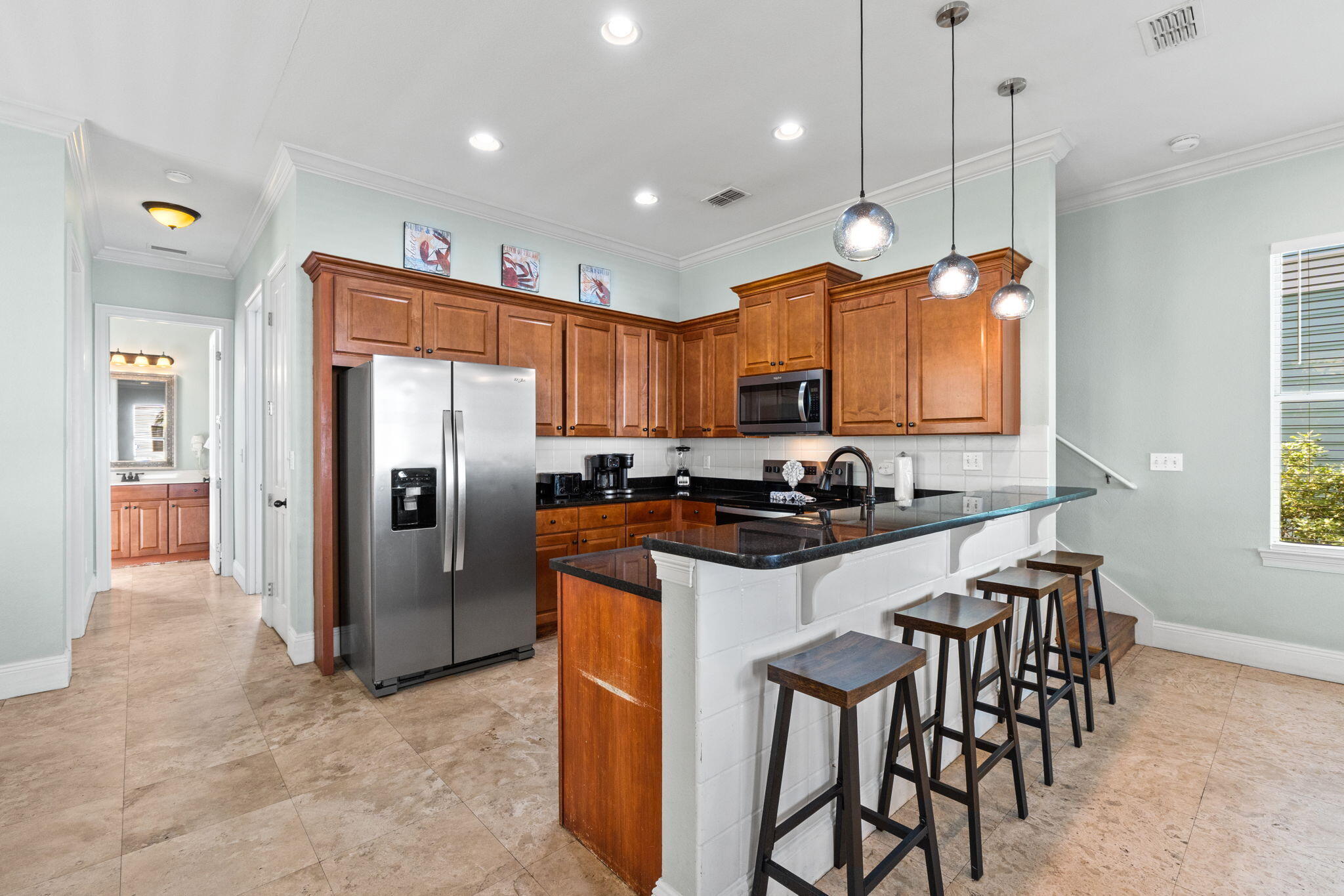 209 Grand Key Loop East Destin, FL 32541 - Photo 6 of 59 a kitchen with granite countertop a refrigerator a stove a sink a dining table and chairs