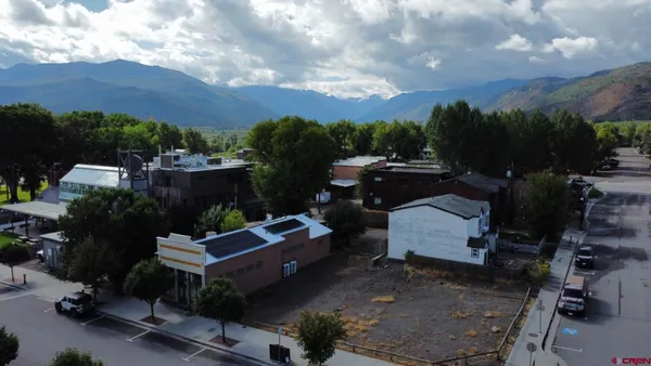 an aerial view of a house with a yard