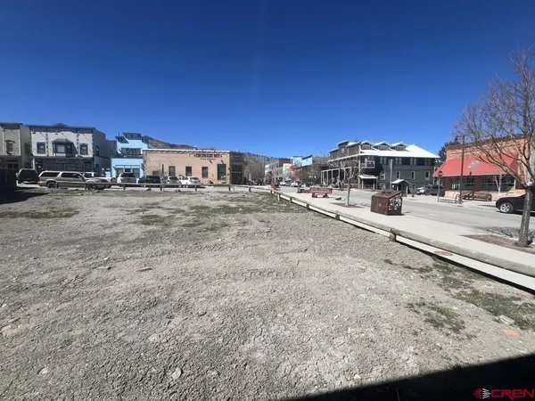 a view of a dirt road and a building