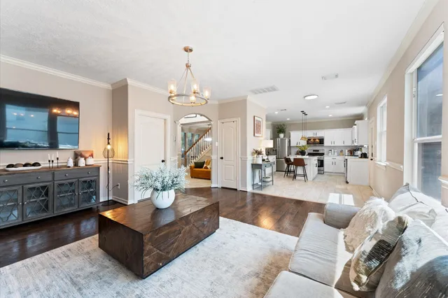 a bathroom with a sink a toilet a mirror and shower