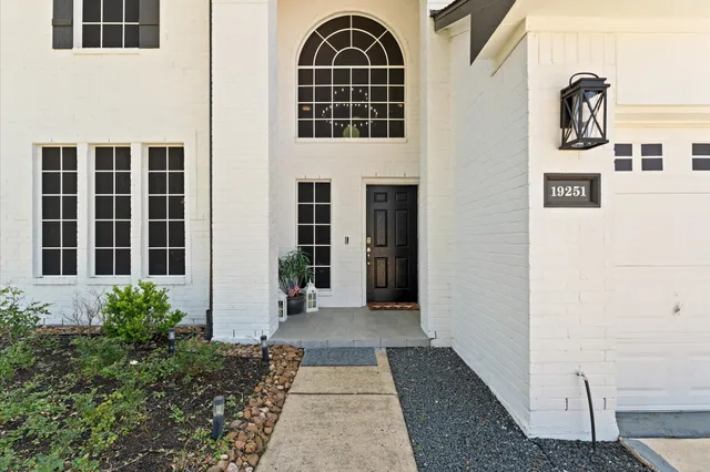 a bedroom with a bed potted plant and a large mirror