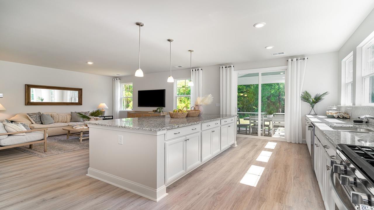 571 Haven View Way Murrells Inlet, SC 29576 - Photo 6 of 26 Kitchen with light stone counters, a kitchen islan