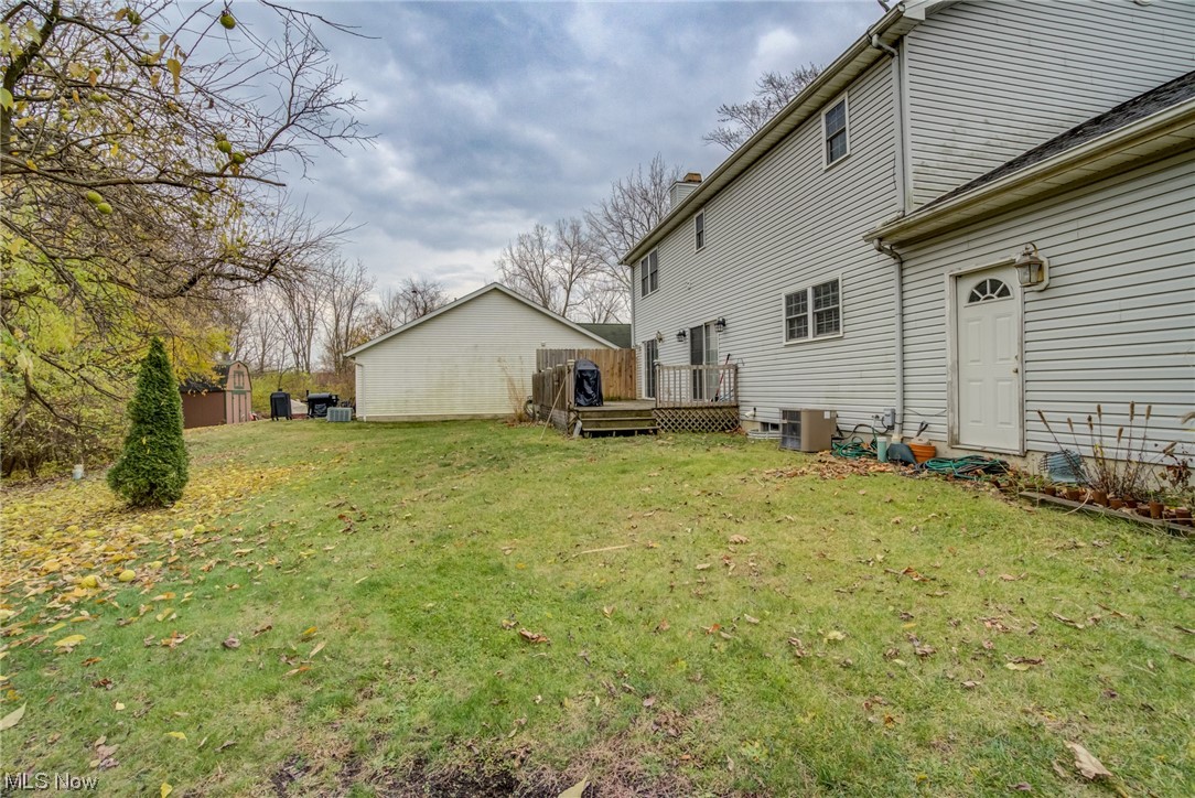 171 Nobottom Road Berea, OH 44017 - Photo 29 of 30 View of yard with central AC and a wooden deck