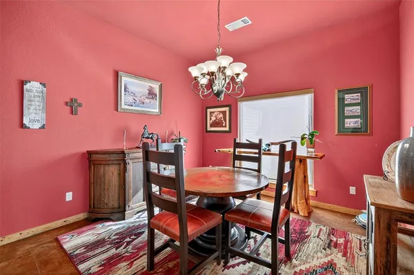 a view of a dining room with furniture and chandelier