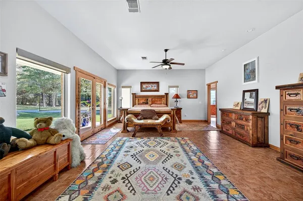 a bedroom with furniture and a large window