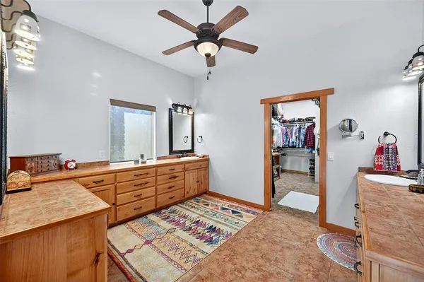 a large bedroom with a bed and a chandelier