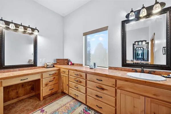 a bathroom with a double vanity sink and mirror