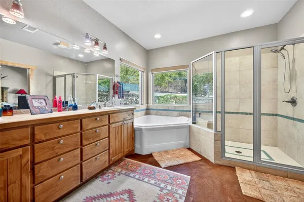 a spacious bathroom with a double vanity sink mirror and large window