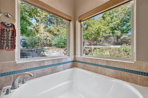 a white bath tub sitting in front of a window