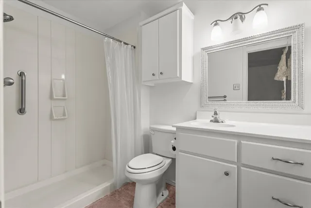 wooden floor in an empty room with a chandelier fan