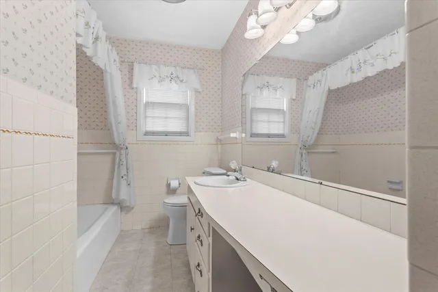 an empty room with a chandelier fan