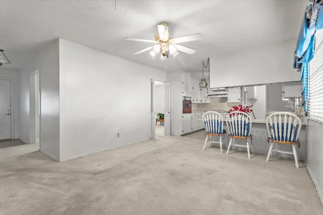 a kitchen with kitchen island granite countertop a sink stainless steel appliances and cabinets