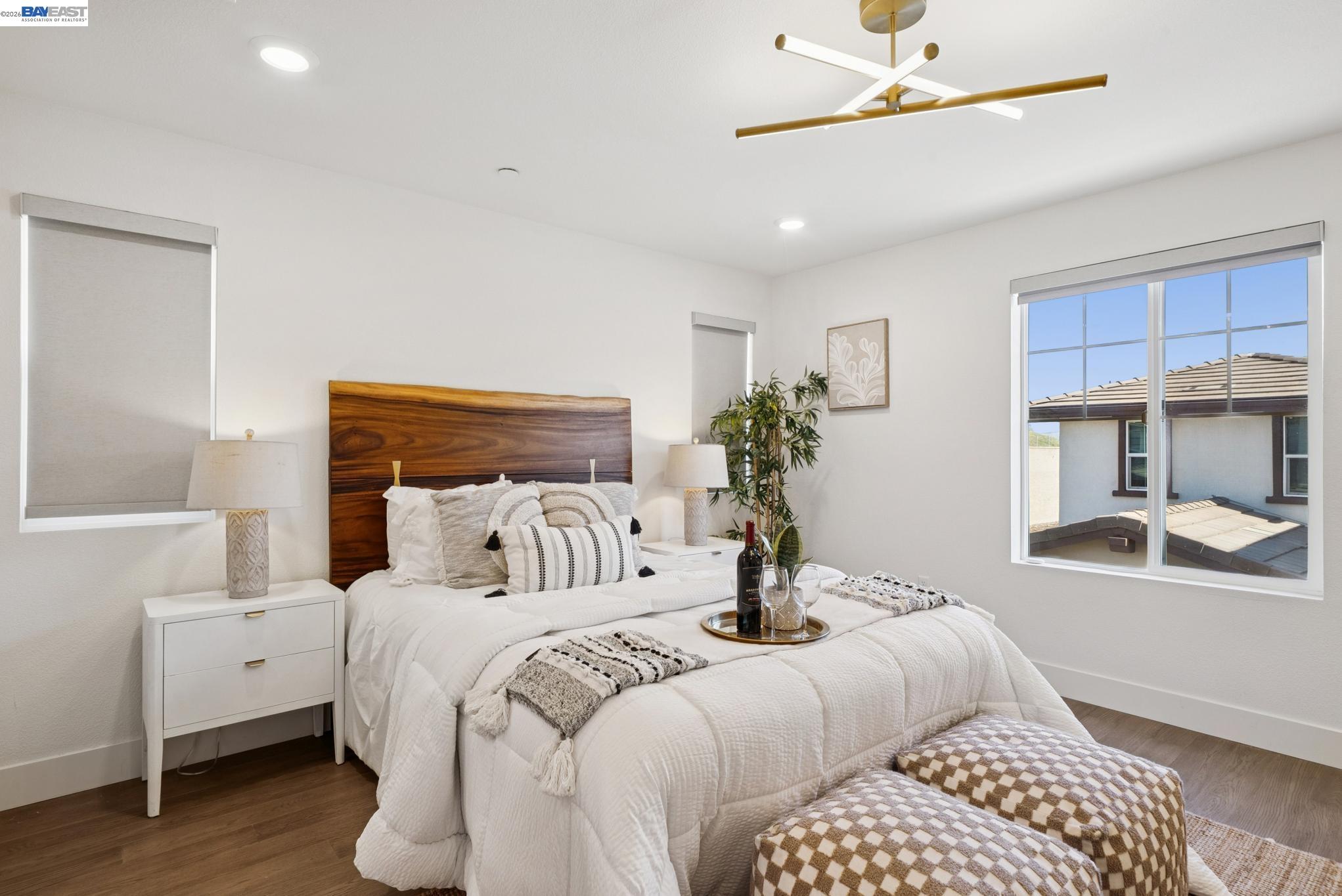 57109 Via Vicenza San Ramon, CA 94583 - Photo 29 of 54 a bedroom with a large bed and a chandelier