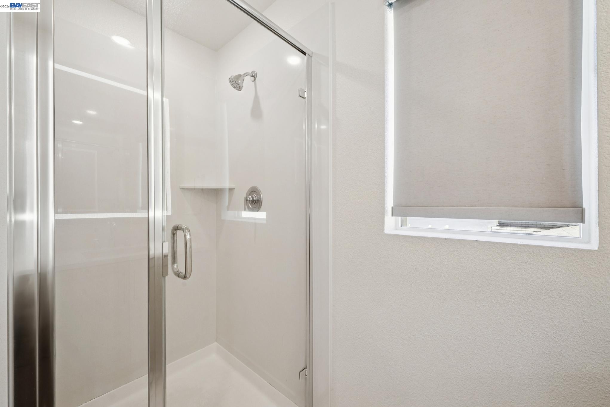 57109 Via Vicenza San Ramon, CA 94583 - Photo 39 of 54 a bathroom with a glass shower door