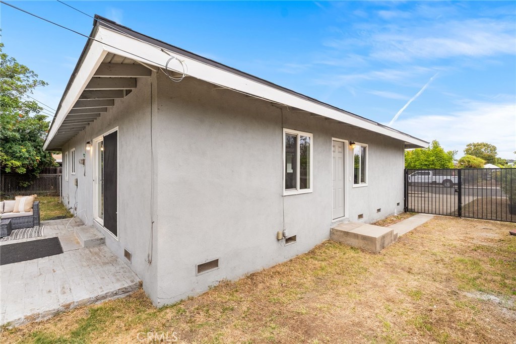 13361 Roxey Drive Garden Grove, CA 92843 - Photo 24 of 31 a backyard of a house with wooden fence and large windows