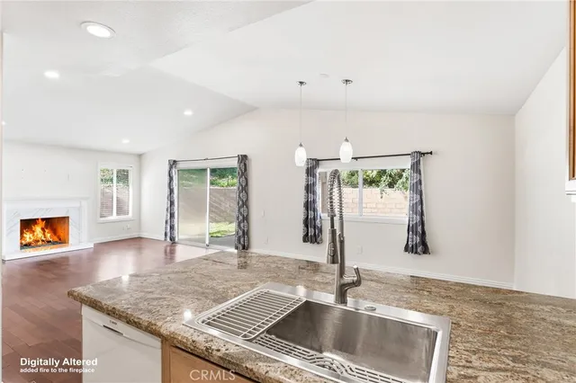 a kitchen with granite countertop a sink and a window