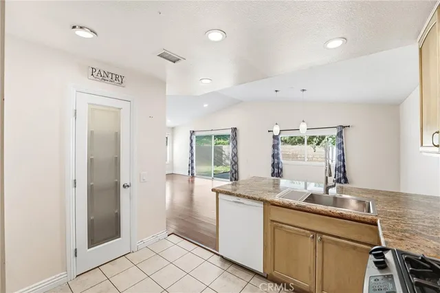 a bathroom with a granite countertop sink mirror and cabinets