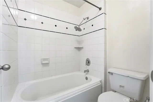 a bathroom with a bathtub and a toilet