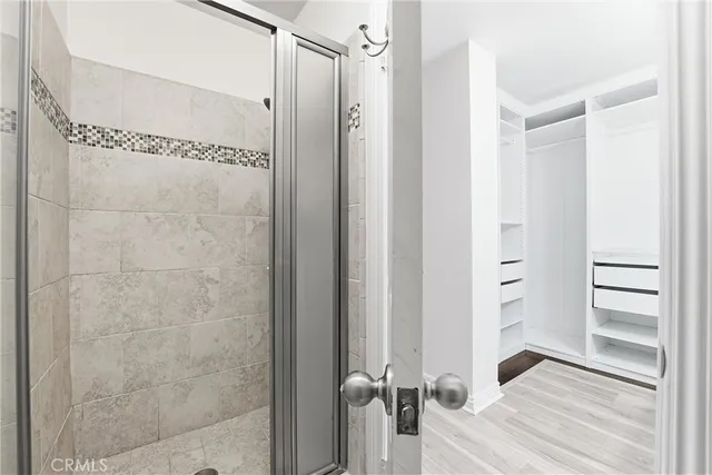 a bathroom with a shower and a glass door