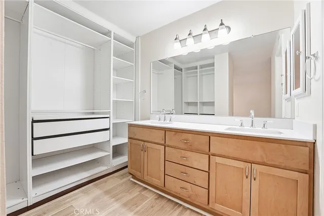a bathroom with a double vanity sink and a mirror