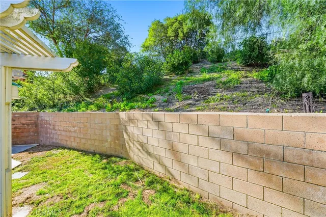 a front view of a house with a yard and a wooden deck