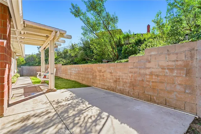 a aerial view of a house with a yard and potted plants