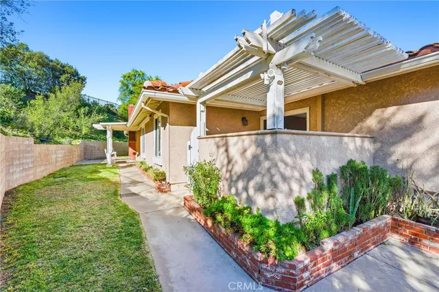 an aerial view of a house with backyard and outdoor seating