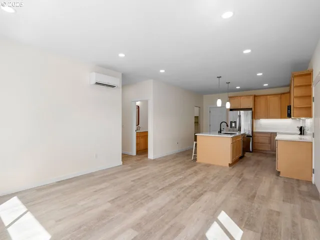 a view of a kitchen with furniture and wooden floor