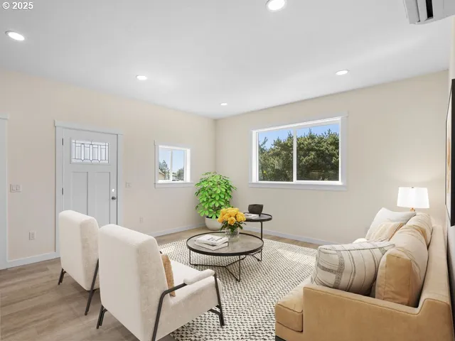 a living room with furniture and a potted plant
