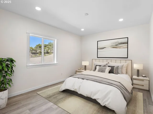 a bedroom with a large bed and a potted plant