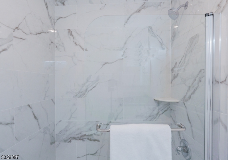 1026 Stuyvesant Avenue, Unit 307 Union, NJ 07083 - Photo 10 of 11 a bathroom with a toilet and a shower