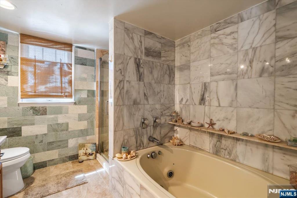 48 Quartz Lane Paterson, NJ 07501 - Photo 12 of 29 a bathroom with a bathtub and a toilet